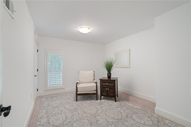 living area featuring baseboards and carpet