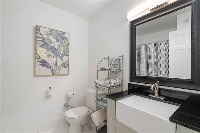 full bath with toilet, vanity, and baseboards