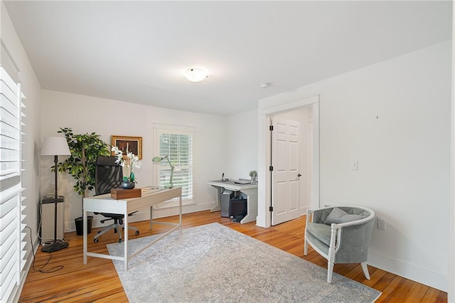office with light wood-style flooring and baseboards
