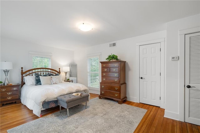 bedroom featuring wood finished floors and baseboards
