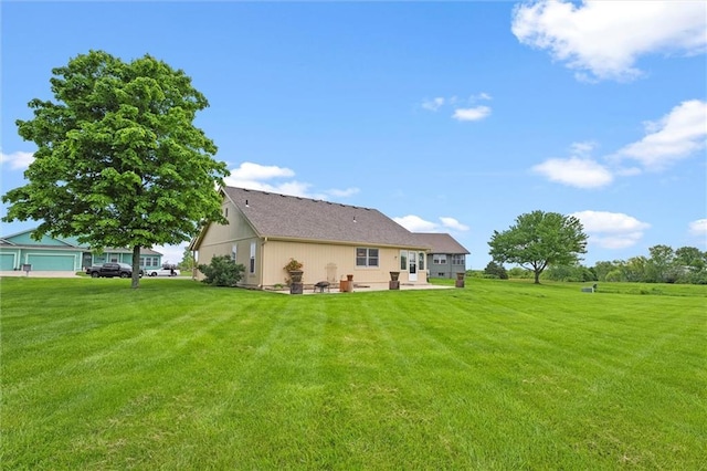 721 Cupid Ct, Raymore, MO 64083 - rear view of house with a yard and a patio area