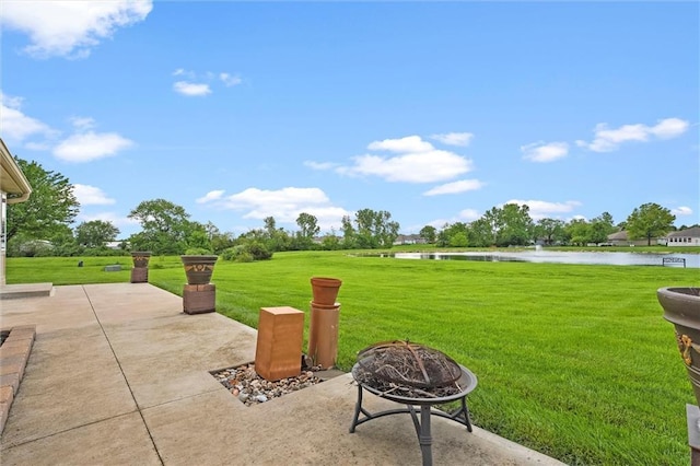 721 Cupid Ct, Raymore, MO 64083 - view of patio with a water view and a fire pit