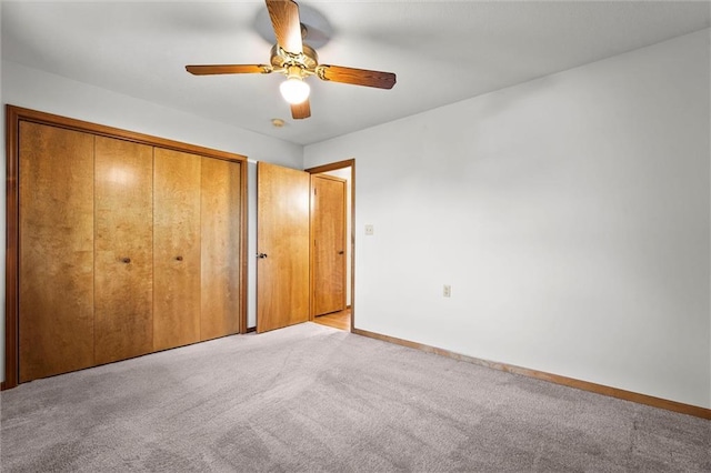 721 Cupid Ct, Raymore, MO 64083 - unfurnished bedroom with light carpet, a closet, baseboards, and a ceiling fan