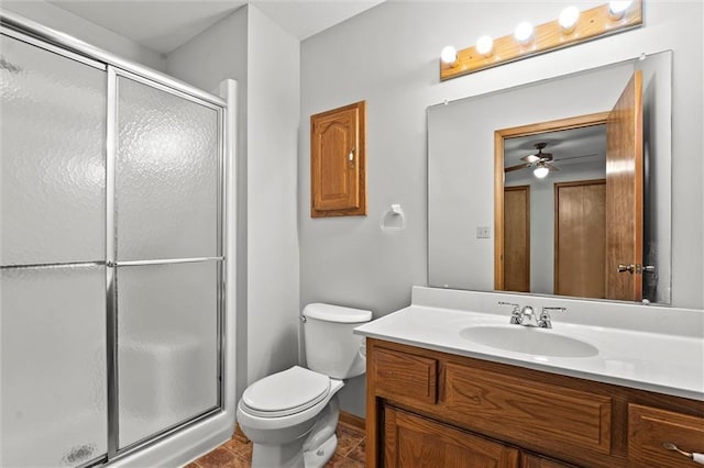 721 Cupid Ct, Raymore, MO 64083 - bathroom featuring a stall shower, vanity, toilet, and a ceiling fan