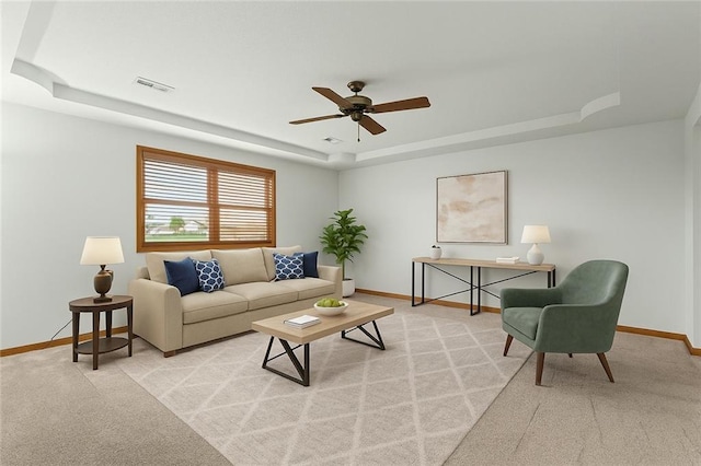 721 Cupid Ct, Raymore, MO 64083 - living room with a tray ceiling, light carpet, baseboards, and ceiling fan