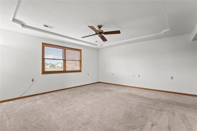 721 Cupid Ct, Raymore, MO 64083 - carpeted spare room with a raised ceiling, baseboards, and ceiling fan