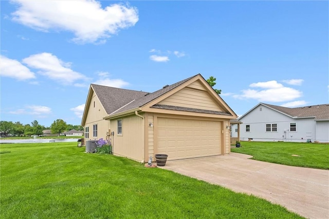 721 Cupid Ct, Raymore, MO 64083 - view of property exterior with cooling unit, a lawn, concrete driveway, roof with shingles, and an attached garage
