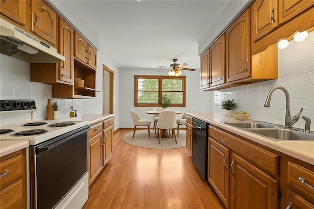 721 Cupid Ct, Raymore, MO 64083 - kitchen featuring electric stove, under cabinet range hood, a sink, dishwasher, and brown cabinets
