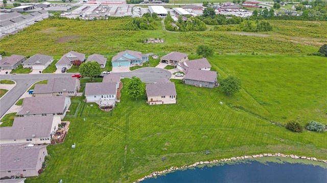 721 Cupid Ct, Raymore, MO 64083 - aerial overview of property's location with a nearby body of water and nearby suburban area