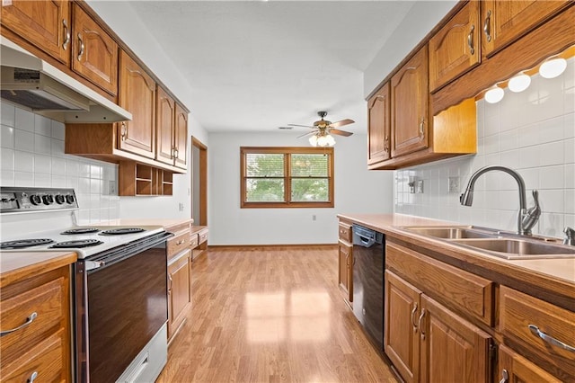 721 Cupid Ct, Raymore, MO 64083 - kitchen featuring range with electric stovetop, black dishwasher, under cabinet range hood, a sink, and decorative backsplash