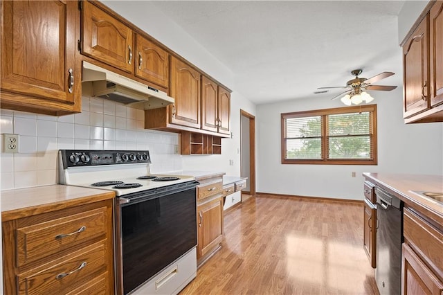721 Cupid Ct, Raymore, MO 64083 - kitchen featuring electric range, under cabinet range hood, dishwasher, brown cabinets, and ceiling fan