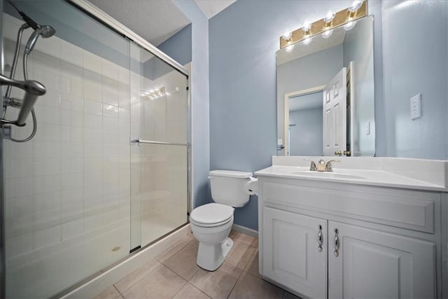 full bath with a shower stall, toilet, tile patterned flooring, vanity, and baseboards
