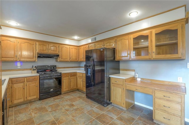 5805 N Belton Ave, Kansas City, MO 64151 - kitchen featuring black appliances, under cabinet range hood, light stone finish floors, light countertops, and glass insert cabinets