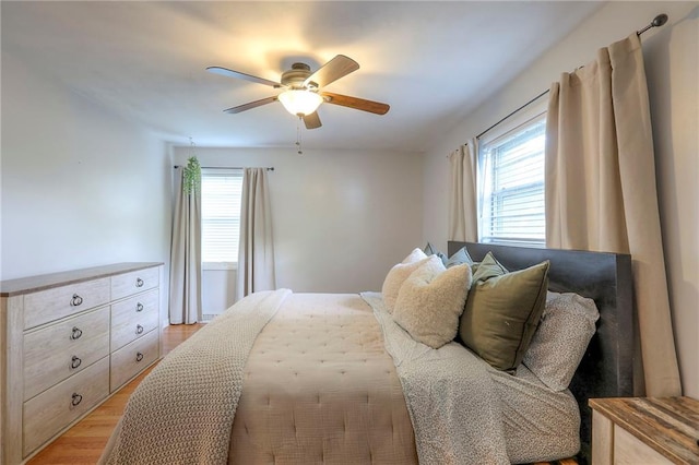 5805 N Belton Ave, Kansas City, MO 64151 - bedroom featuring multiple windows, light wood-type flooring, and ceiling fan