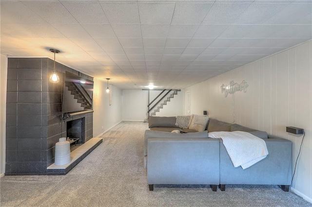 5805 N Belton Ave, Kansas City, MO 64151 - living area with stairway, carpet, baseboards, and a fireplace with raised hearth
