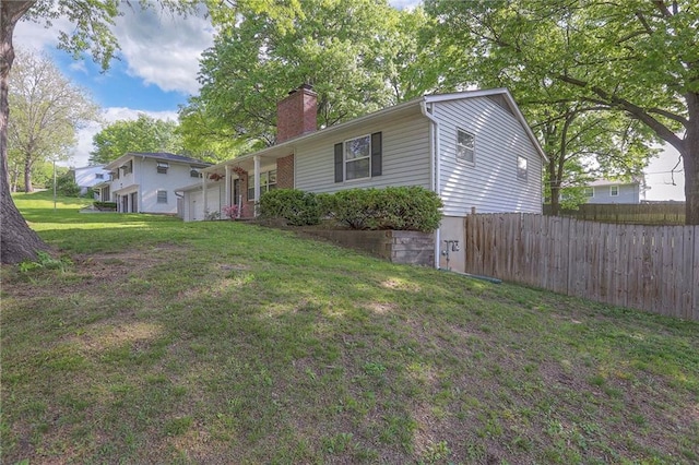 5805 N Belton Ave, Kansas City, MO 64151 - view of side of property with a chimney and an attached garage