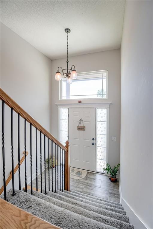 21200 W 47th Ter, Shawnee, KS 66218 - entryway with a chandelier, stairs, and baseboards