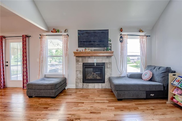 21200 W 47th Ter, Shawnee, KS 66218 - living area featuring vaulted ceiling, healthy amount of natural light, wood finished floors, and a fireplace