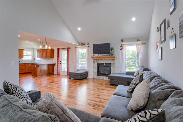 21200 W 47th Ter, Shawnee, KS 66218 - living room with high vaulted ceiling, healthy amount of natural light, a tiled fireplace, a chandelier, and recessed lighting