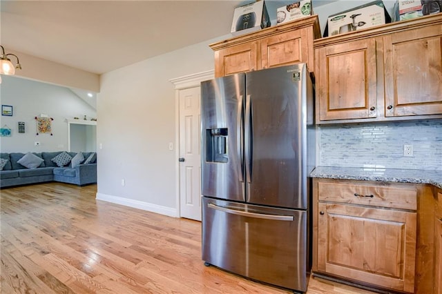 21200 W 47th Ter, Shawnee, KS 66218 - kitchen with stainless steel refrigerator with ice dispenser, decorative backsplash, light wood finished floors, light stone counters, and open floor plan