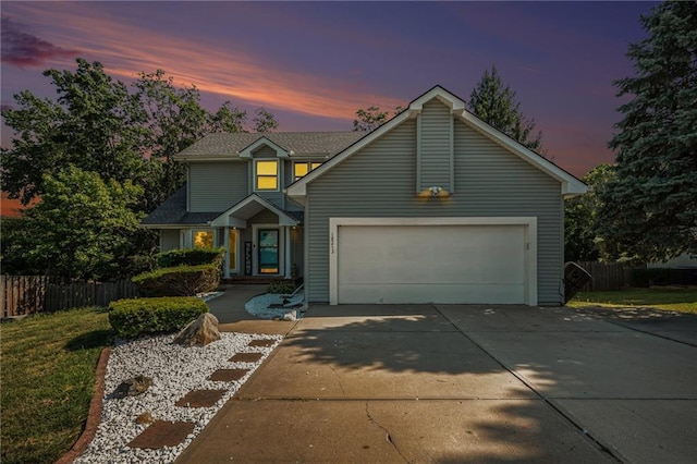 traditional-style home with fence, concrete driveway, and an attached garage