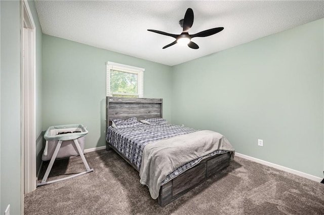 carpeted bedroom featuring baseboards, ceiling fan, and a textured ceiling