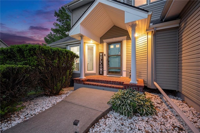 view of exterior entry with covered porch