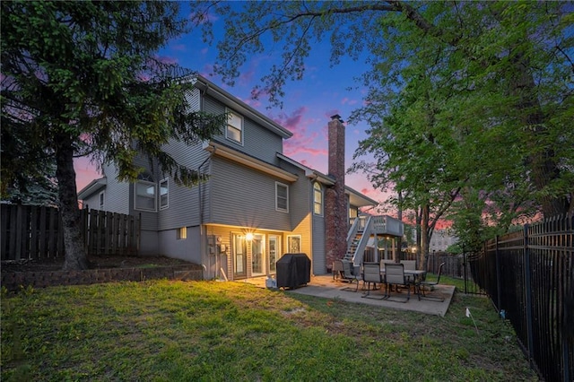 rear view of property with a chimney, stairs, and a patio area