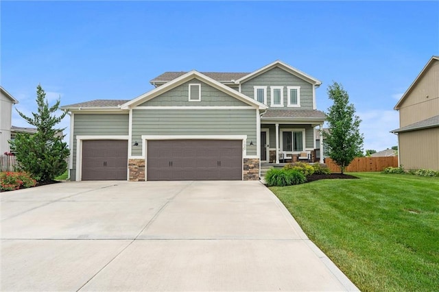 100 SW Ayden Ln, Blue Springs, MO 64064 - craftsman house featuring an attached garage, driveway, covered porch, and stone siding