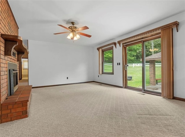 unfurnished living room featuring carpet, plenty of natural light, and ceiling fan