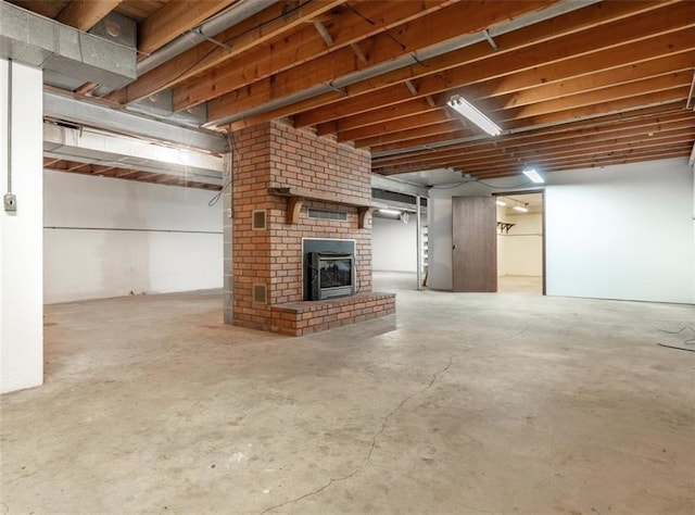 basement featuring a brick fireplace