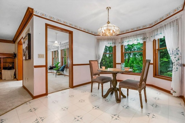 2820 S Victoria Ln, Blue Springs, MO 64015 - dining area featuring a chandelier, baseboards, ornamental molding, and light carpet