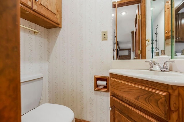 2820 S Victoria Ln, Blue Springs, MO 64015 - bathroom featuring toilet, wallpapered walls, and vanity