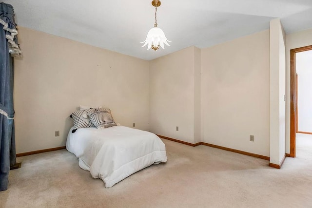 2820 S Victoria Ln, Blue Springs, MO 64015 - bedroom with carpet floors, a chandelier, and baseboards