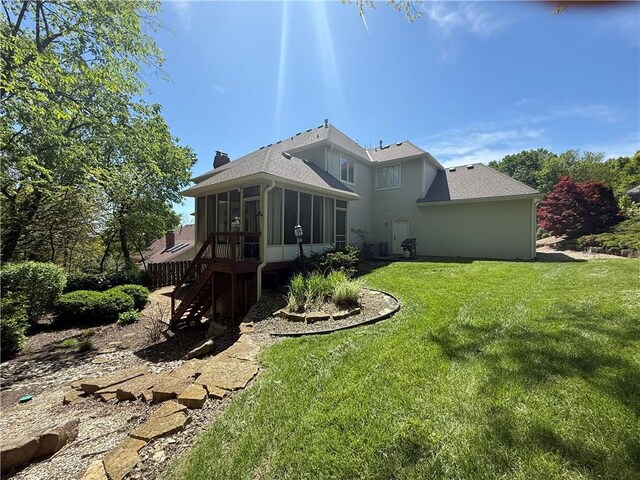 1605 Ridge Rd, Leavenworth, KS 66048 - rear view of house featuring a sunroom, stairway, a lawn, and roof with shingles