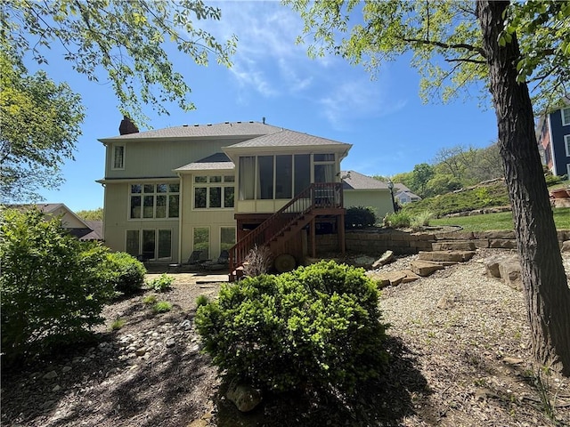1605 Ridge Rd, Leavenworth, KS 66048 - back of property with a sunroom, stairway, and a chimney