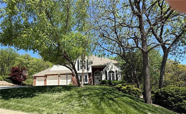 1605 Ridge Rd, Leavenworth, KS 66048 - tudor house with a front yard, a garage, and driveway