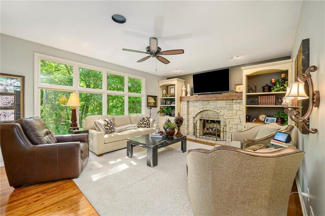 1605 Ridge Rd, Leavenworth, KS 66048 - living area featuring wood finished floors, a ceiling fan, and a fireplace