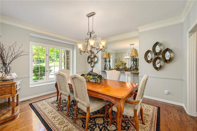 1605 Ridge Rd, Leavenworth, KS 66048 - dining room featuring ornamental molding, a chandelier, light wood-style flooring, and baseboards