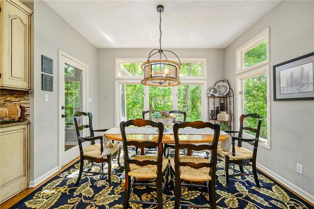 1605 Ridge Rd, Leavenworth, KS 66048 - dining space featuring baseboards, wood finished floors, and a chandelier