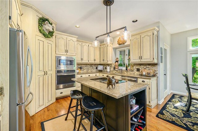 1605 Ridge Rd, Leavenworth, KS 66048 - kitchen featuring stainless steel appliances, backsplash, cream cabinets, light wood-type flooring, and recessed lighting