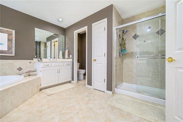 1605 Ridge Rd, Leavenworth, KS 66048 - full bath featuring a shower stall, tile patterned flooring, toilet, a bath, and vanity