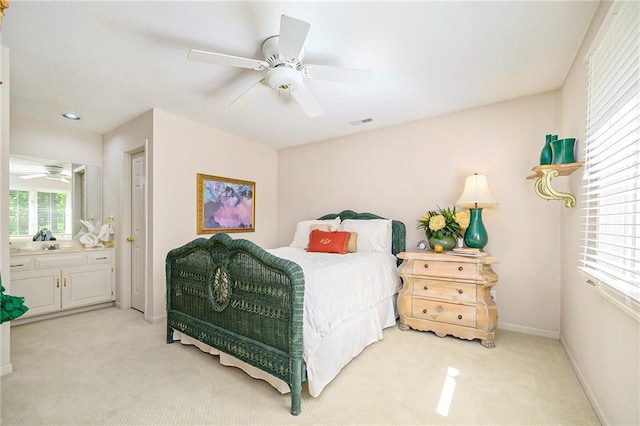 1605 Ridge Rd, Leavenworth, KS 66048 - bedroom with light carpet, connected bathroom, ceiling fan, and baseboards