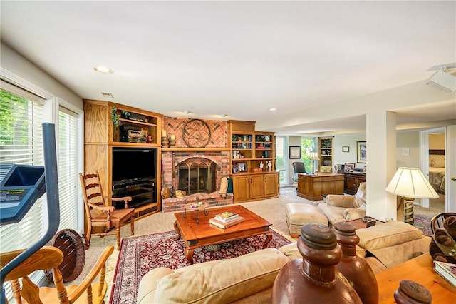1605 Ridge Rd, Leavenworth, KS 66048 - living area with light colored carpet, healthy amount of natural light, a fireplace, and built in features