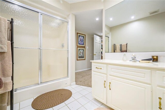 1605 Ridge Rd, Leavenworth, KS 66048 - full bath featuring a shower stall, tile patterned floors, vanity, recessed lighting, and baseboards