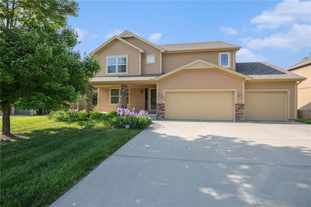 view of front of home with an attached garage, concrete driveway, a front yard, covered porch, and stone siding