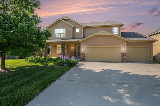 view of front of property with a garage, driveway, a lawn, a porch, and stone siding