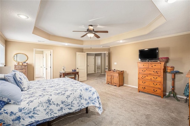 bedroom with a tray ceiling, ornamental molding, light colored carpet, baseboards, and ceiling fan