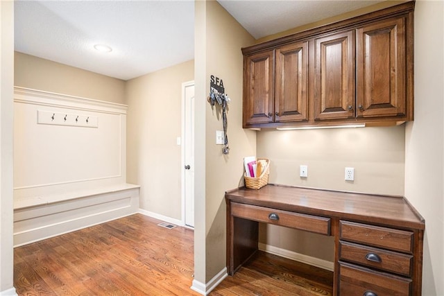 home office featuring wood finished floors and baseboards