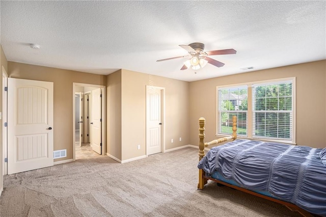bedroom featuring carpet, baseboards, a textured ceiling, and ceiling fan